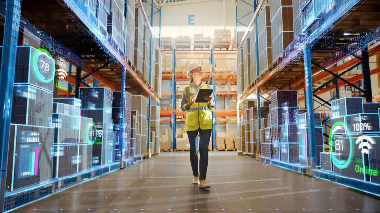 Technician in a warehouse using digital tools, showcasing the advanced capabilities of a contract electronic manufacturer.