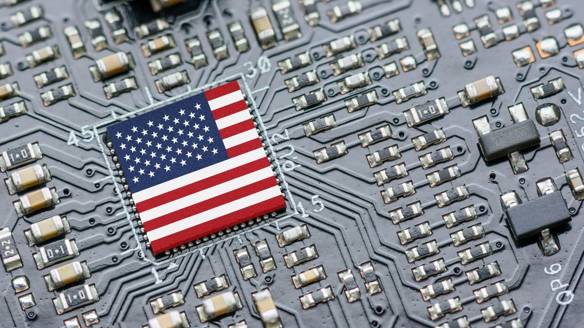 A microchip with the U.S. flag on a circuit board, symbolizing the on shoring of electronics in the US and tech growth.